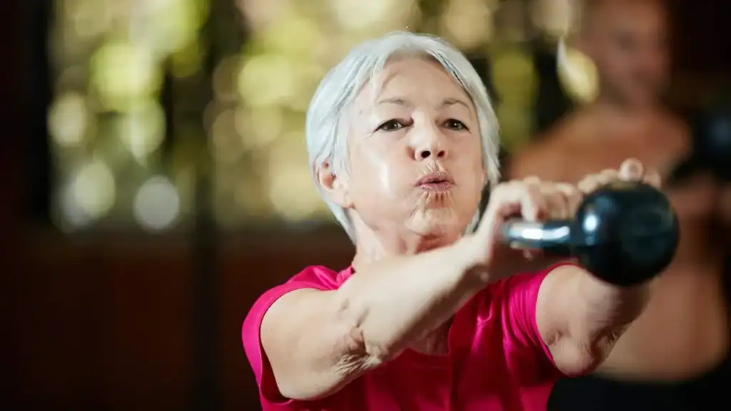 Toning Arms After 60: Empowering Womens Fitness Through Effective Weight Training 1 Older woman doing weight training Wakefield to help her strength and longevity